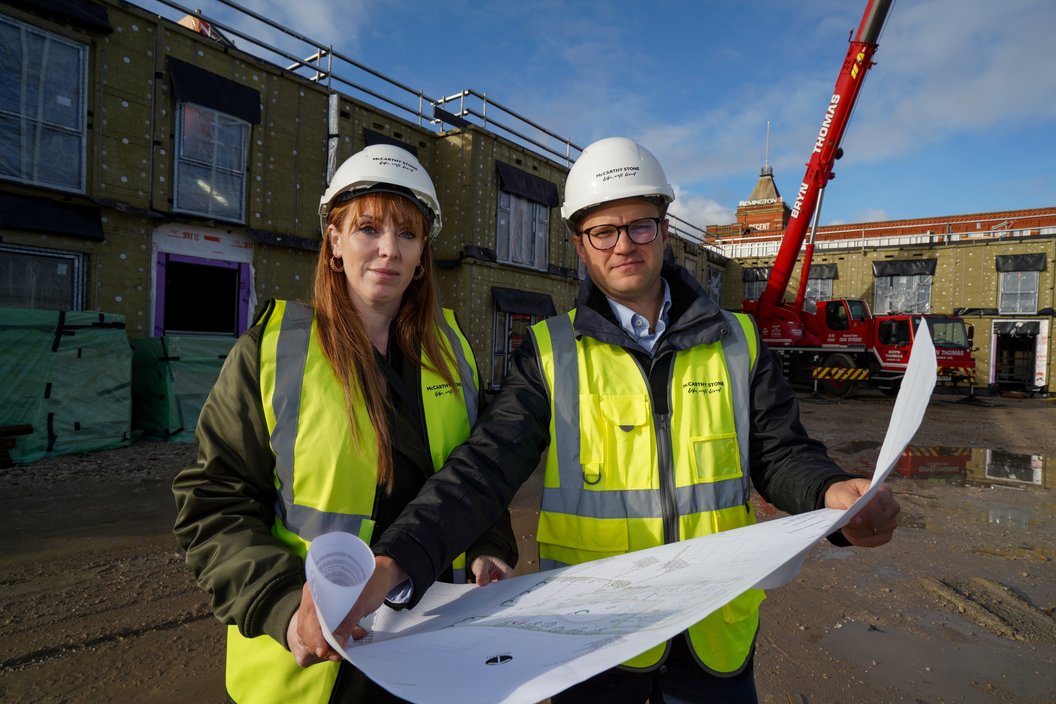 a couple of people wearing hardhats and hard hats