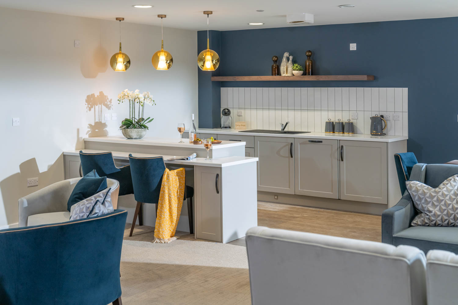 a kitchen with a bar and chairs