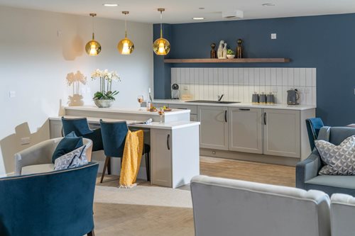 a kitchen with a bar and chairs