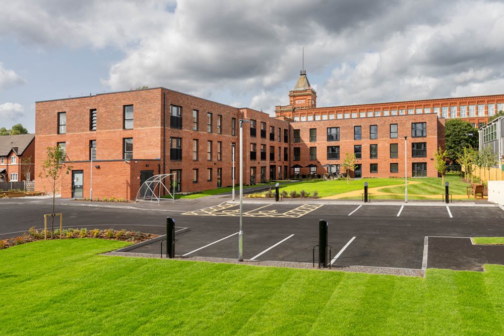 a large brick building with a parking lot in front of it