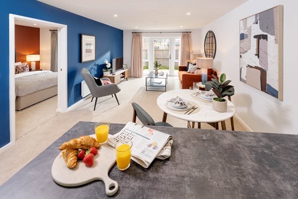 a living room with a bed and a table