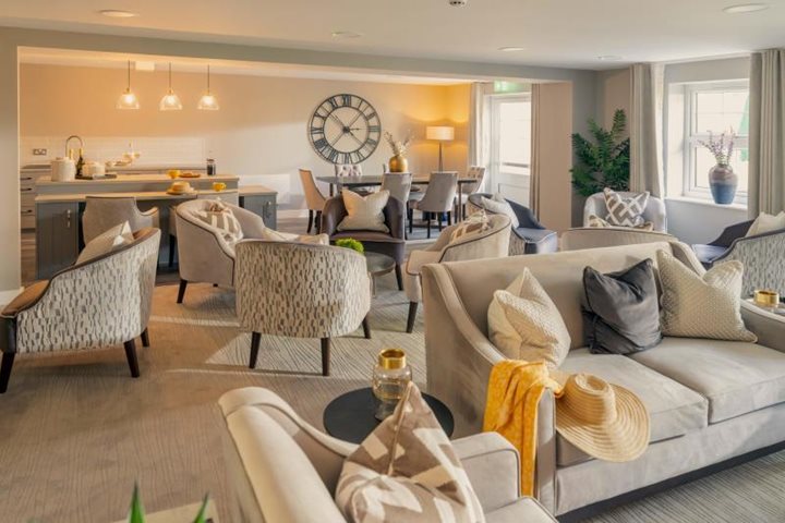 a living room with a couch and chairs