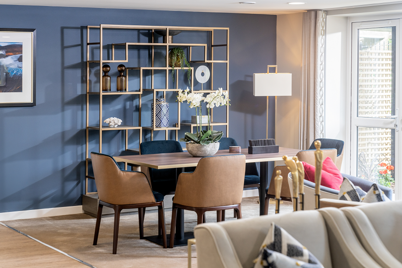 a dining room with a table and chairs