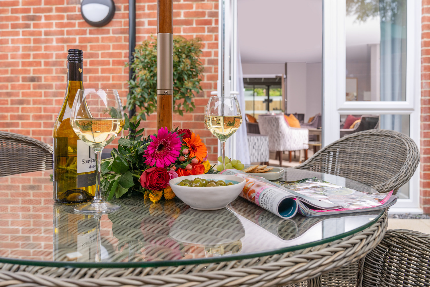 a table with wine glasses and flowers