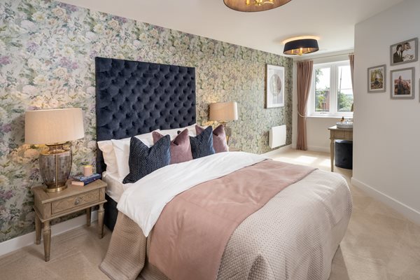 a bedroom with a bed and lamps