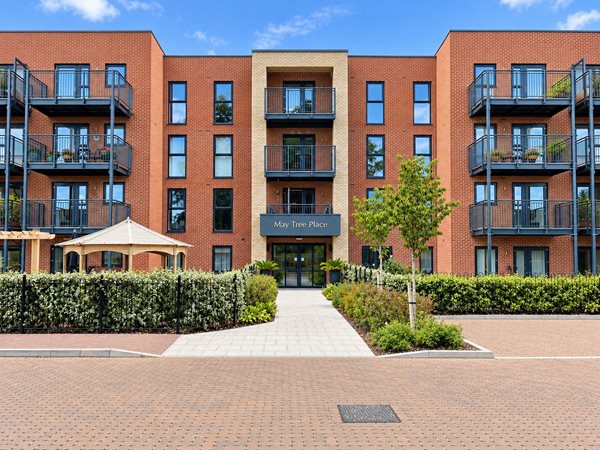 a building with a walkway and trees