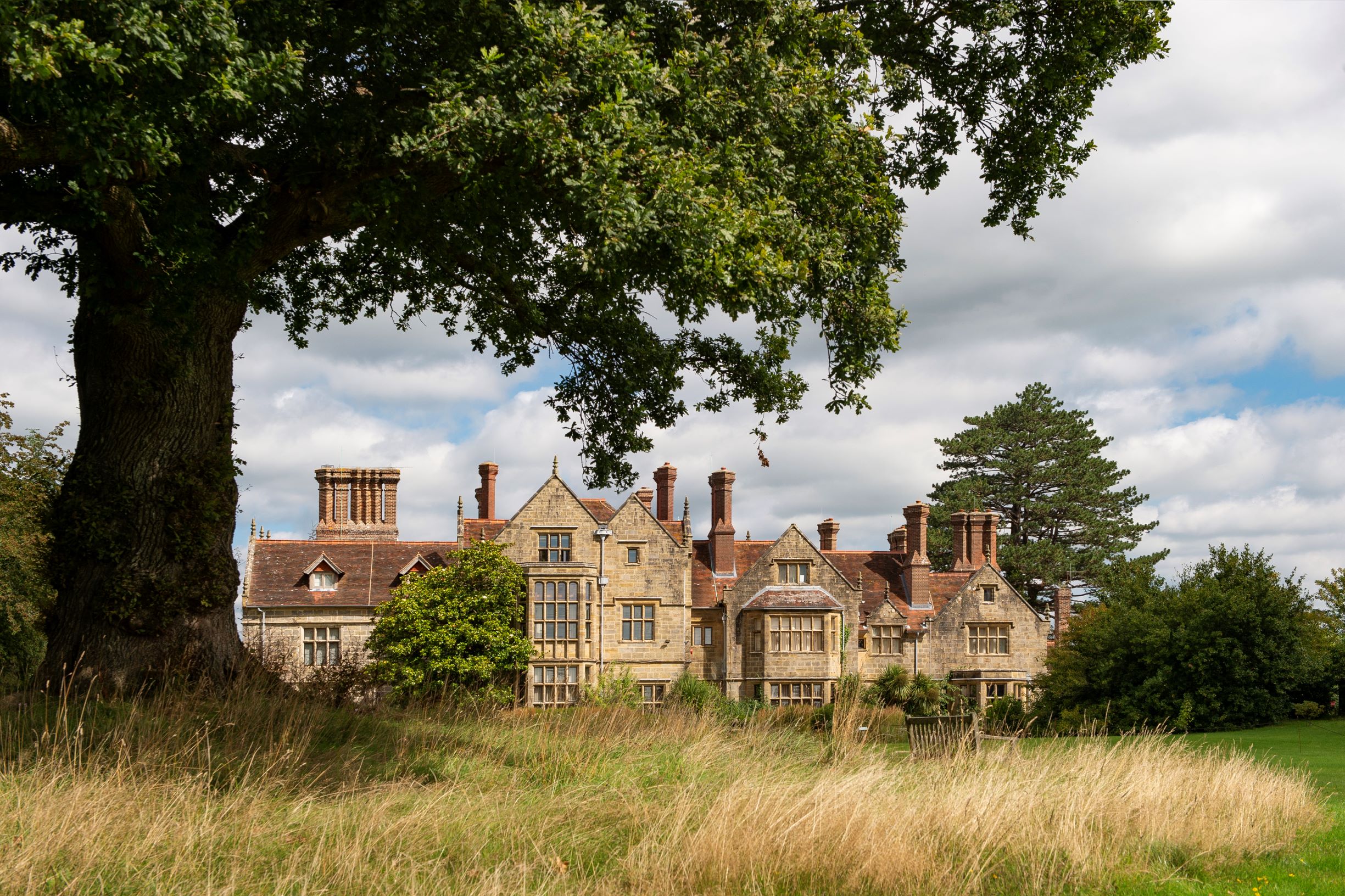 a large house with a tree in front of it