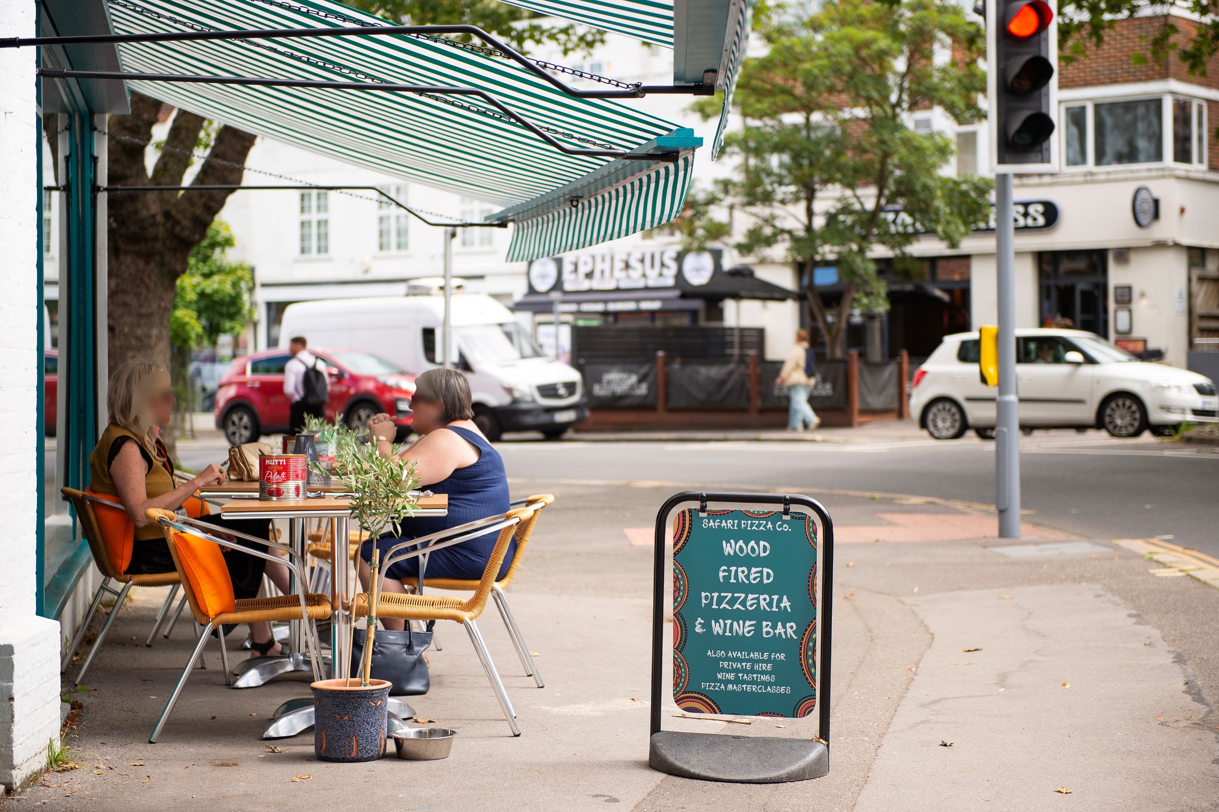 a couple of people sitting at a table outside