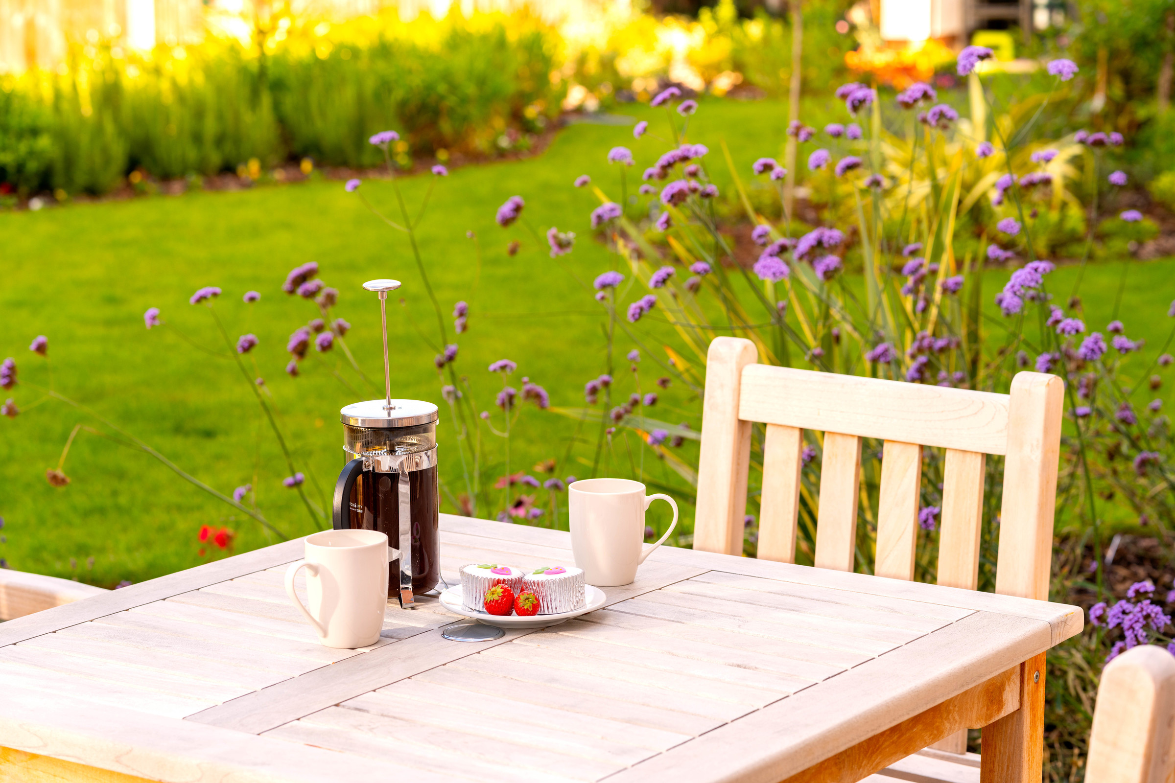 a table with a vase and cups on it