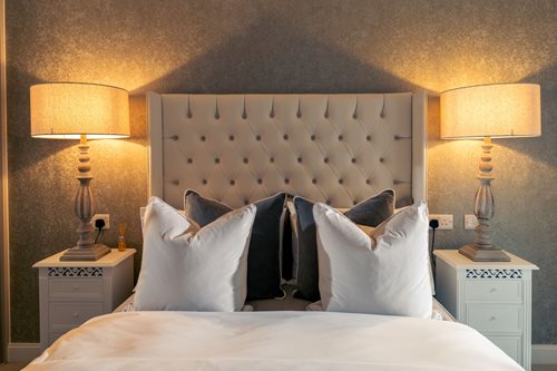 a bed with lamps on either side