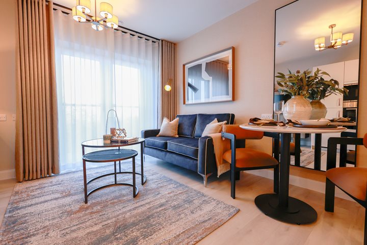 a living room with a blue couch and a table