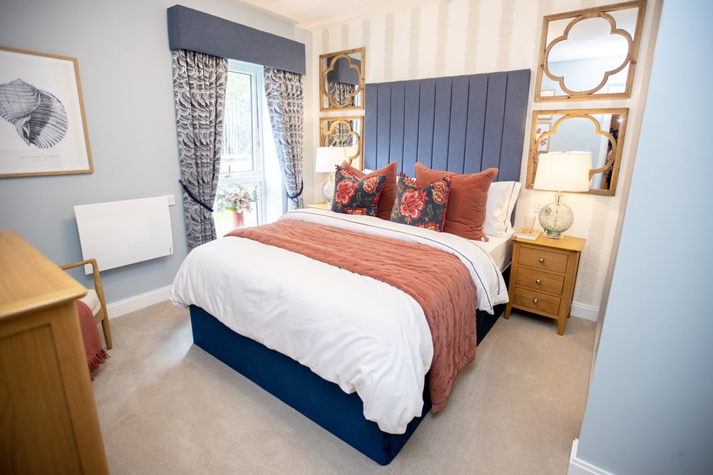 a bedroom with a bed and a mirror