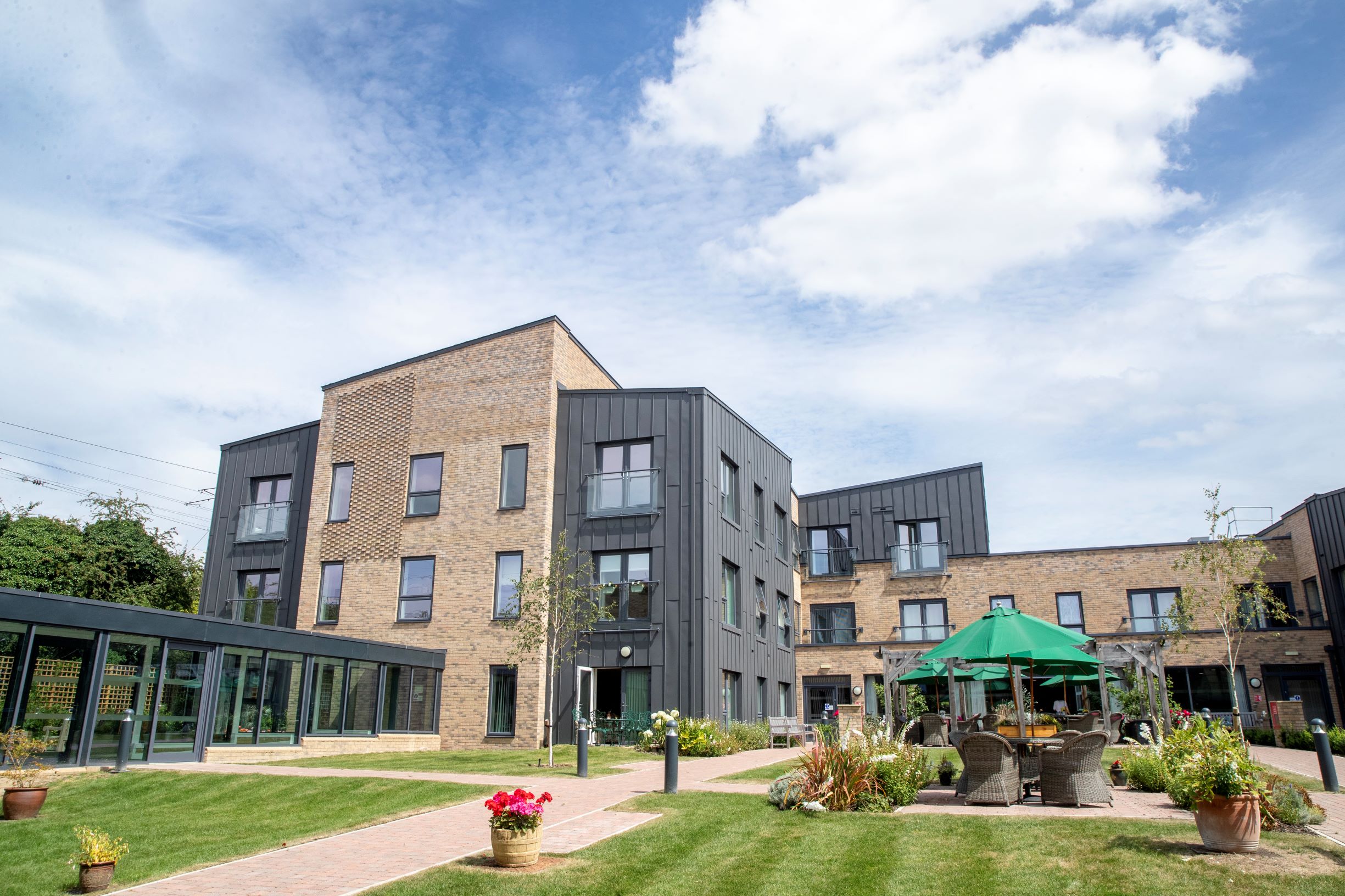 a building with a courtyard and a patio with a table and chairs