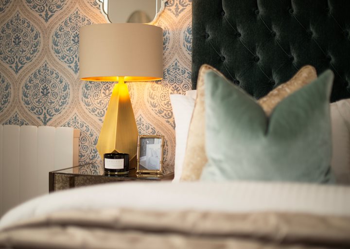 a lamp and pillows on a bed