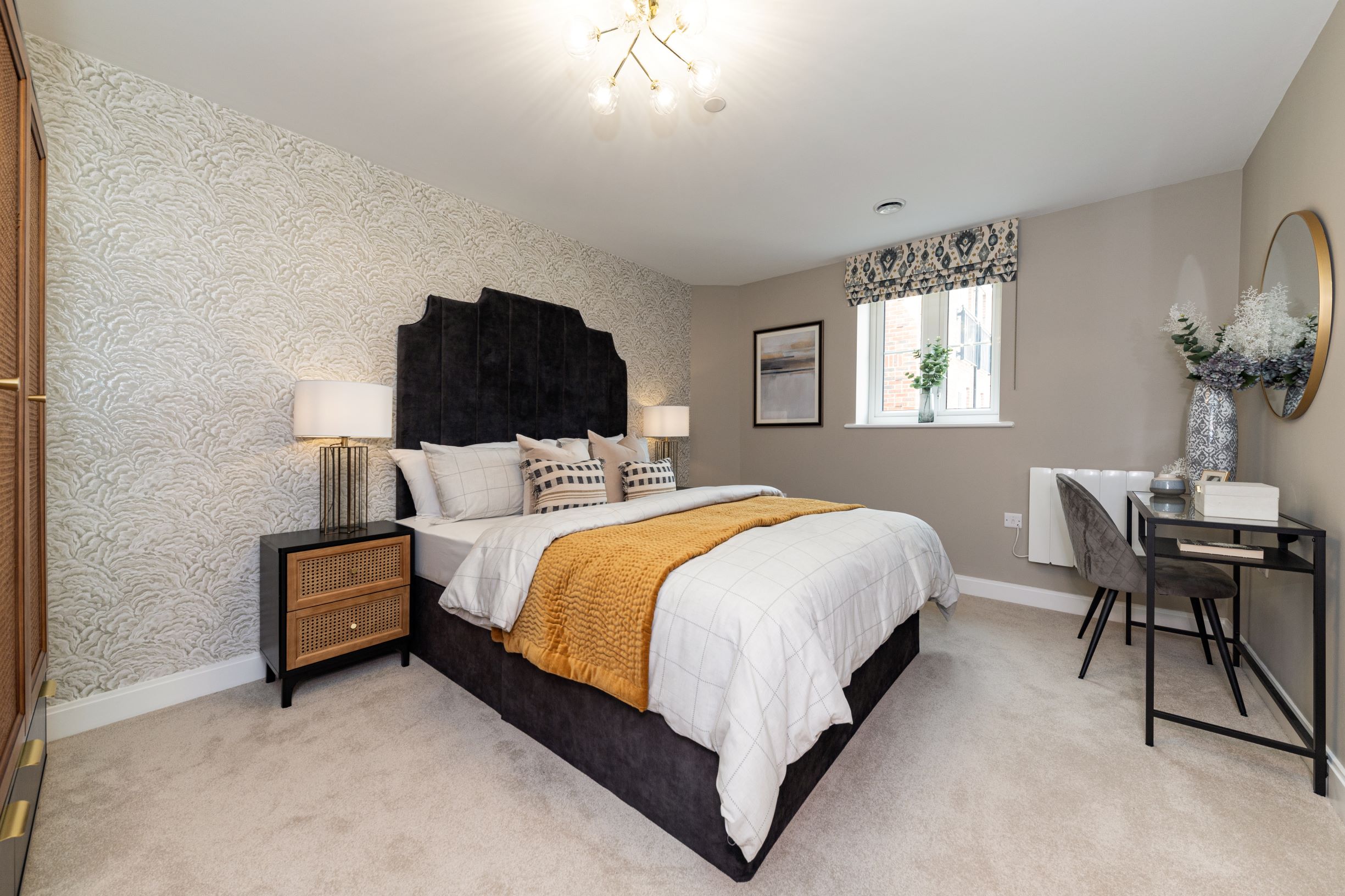 a bedroom with a bed and a desk