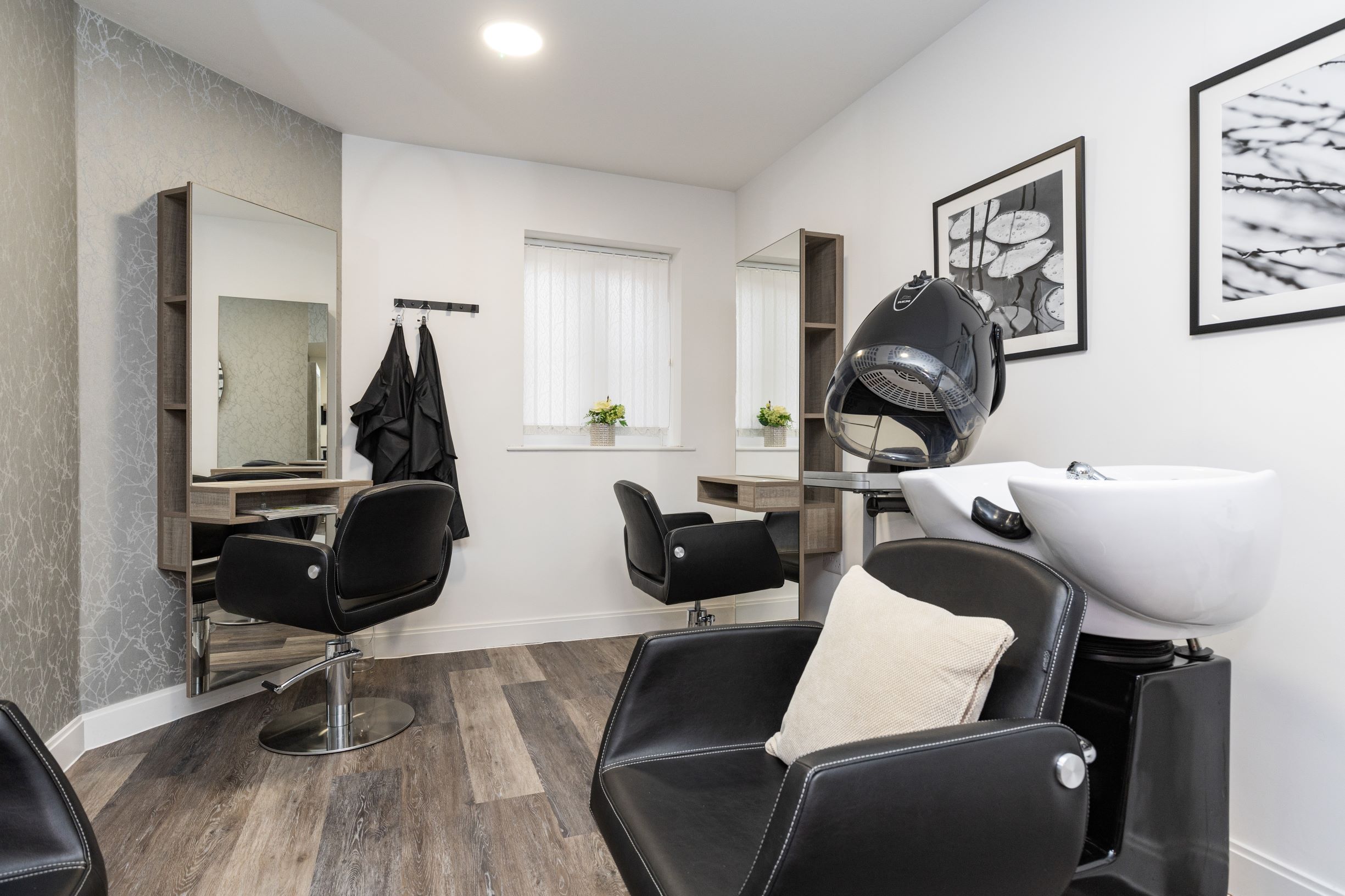a bathroom with a bathtub and chairs