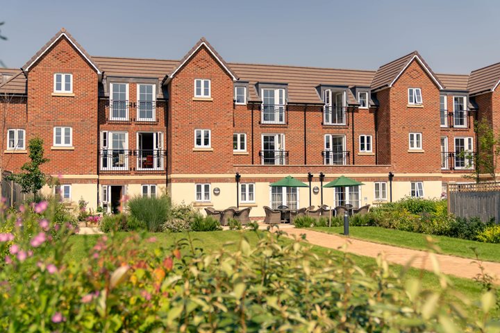 a large brick building with a green roof