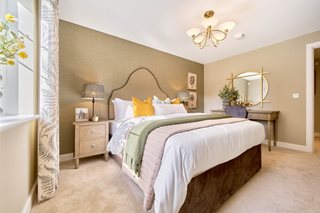 a bedroom with a bed and lamps