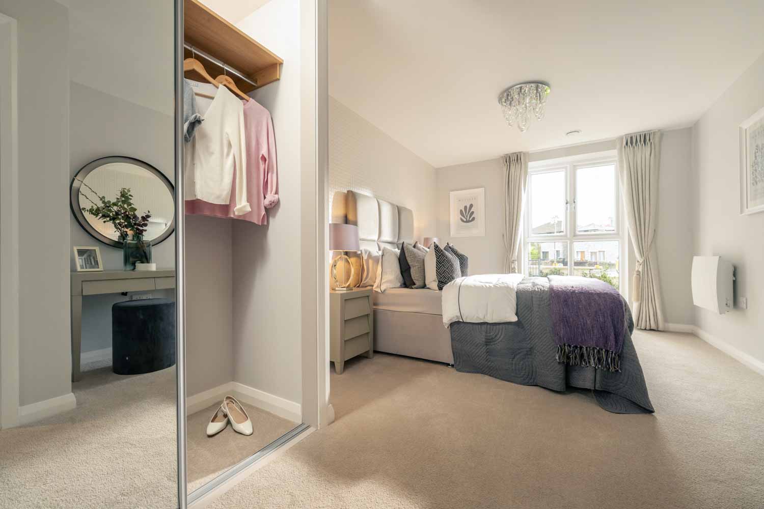 a bedroom with a bed and a mirror
