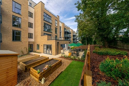 a backyard with a pool and a building