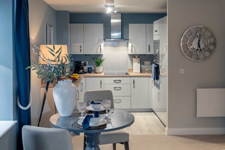 a kitchen with a table and chairs
