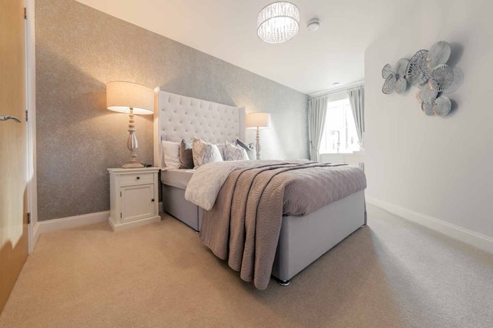 a bedroom with a bed and a lamp