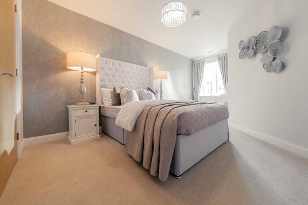 a bedroom with a bed and a lamp