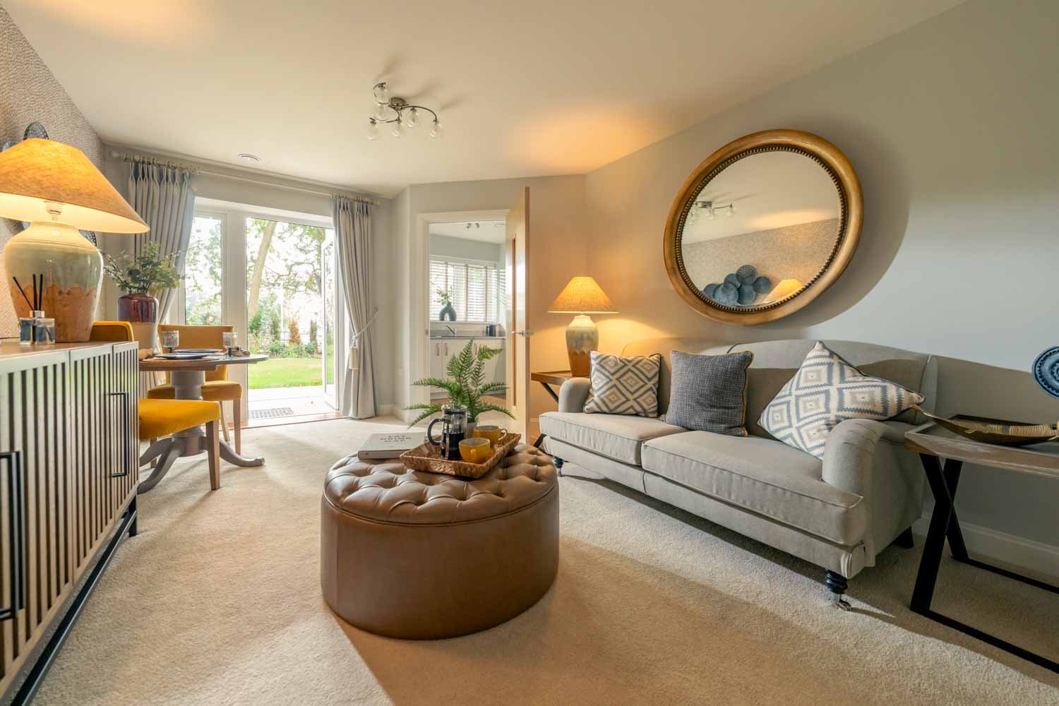 a living room with a white couch and a large mirror