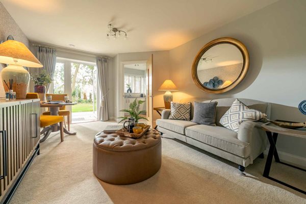 a living room with a white couch and a large mirror