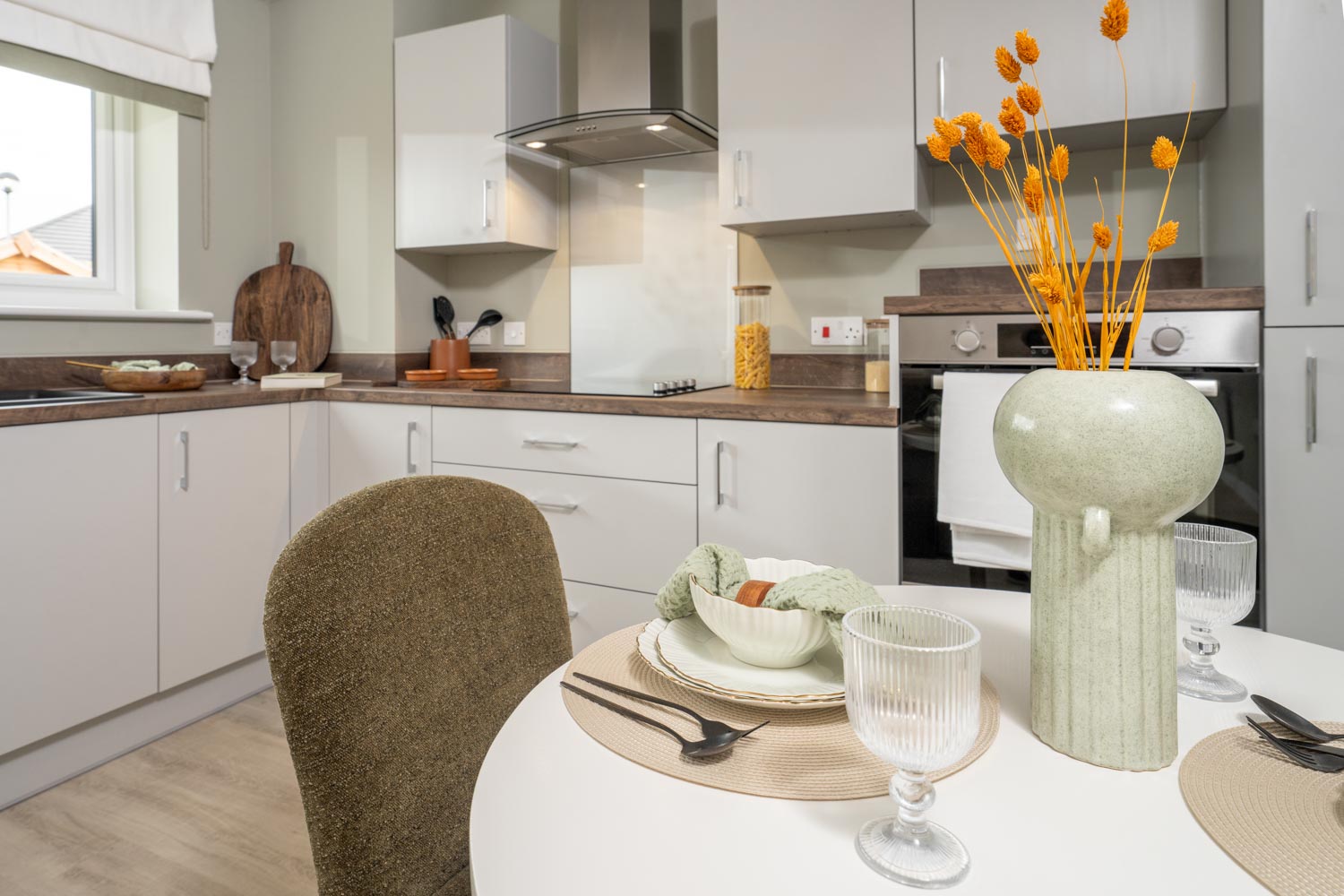 a kitchen with a table and chairs