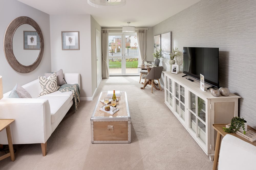 a living room with a white couch and a tv