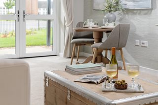a table with a glass of wine and a bottle of wine