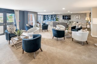 a room with a couch and chairs