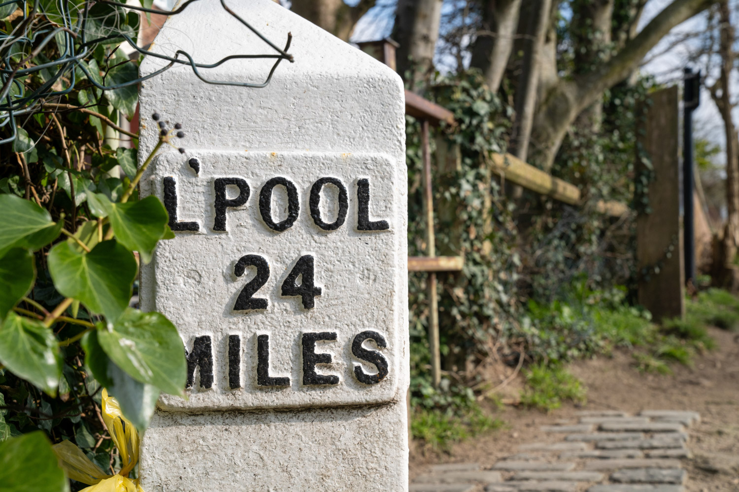 a sign on a stone wall