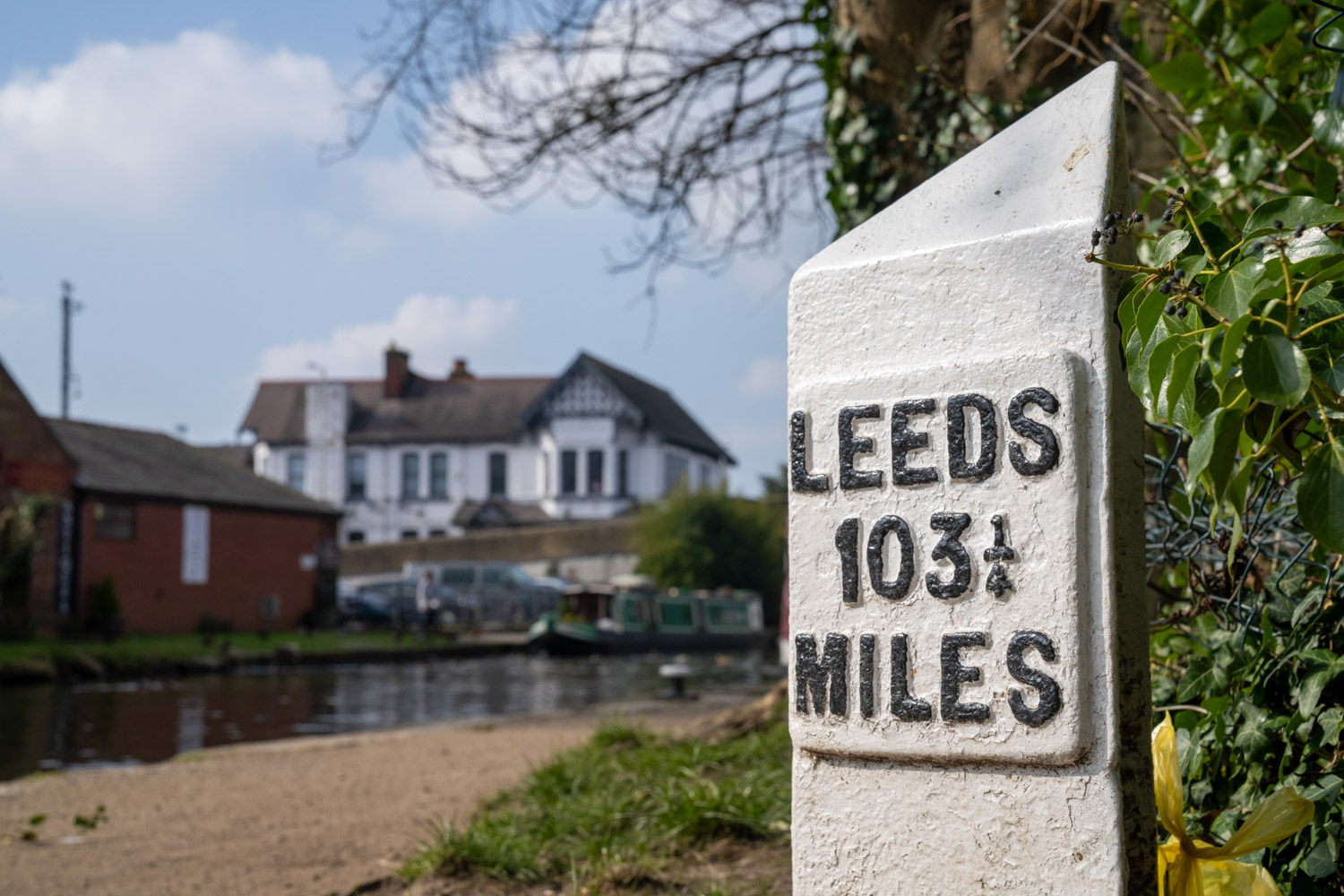 a sign in front of a river