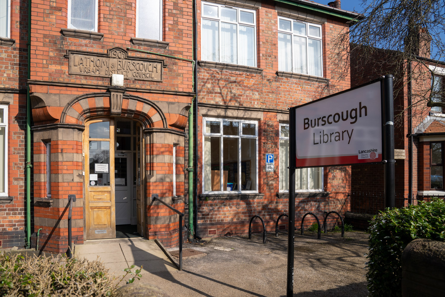 a brick building with a sign in front of it