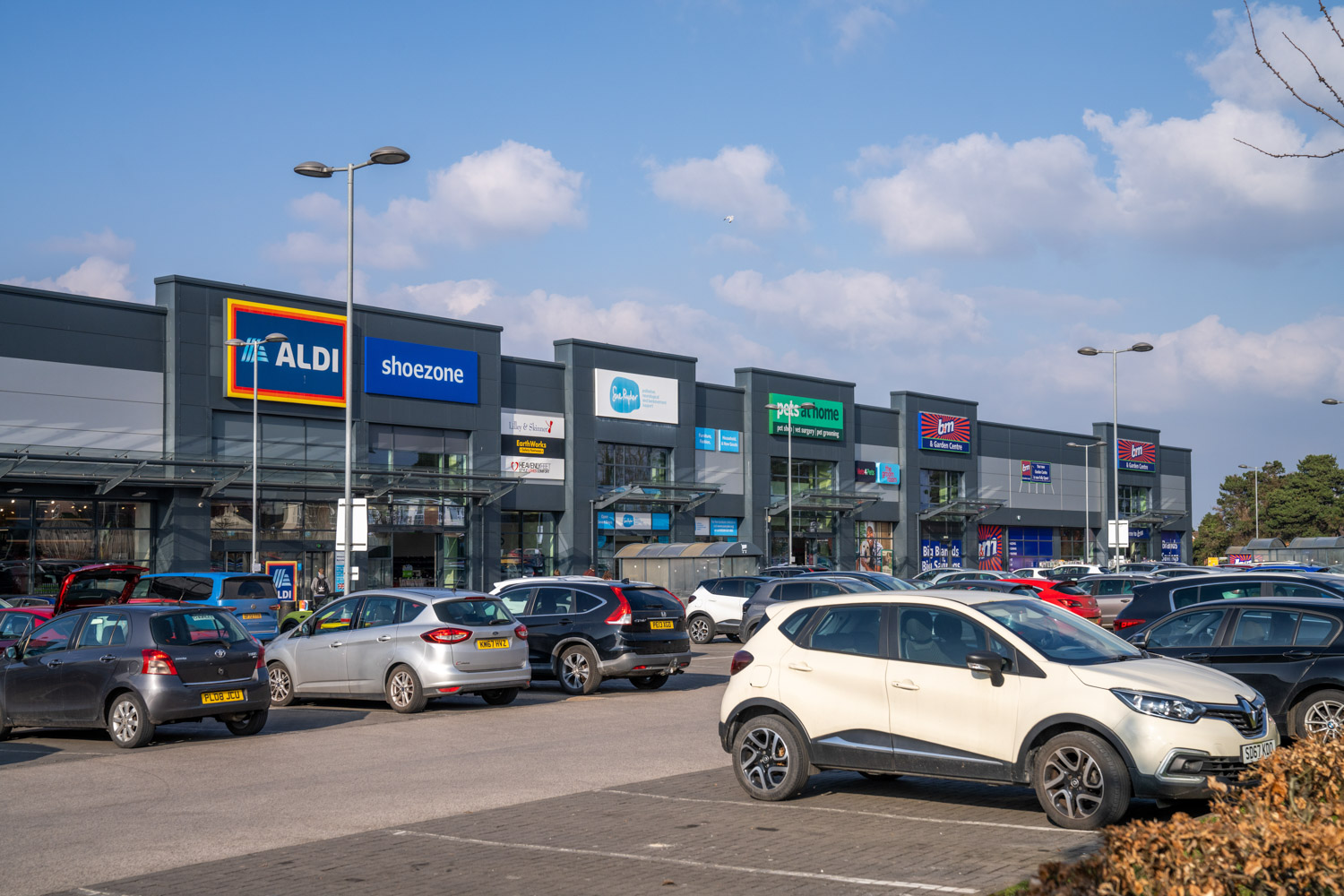 a parking lot with cars and a building in the background