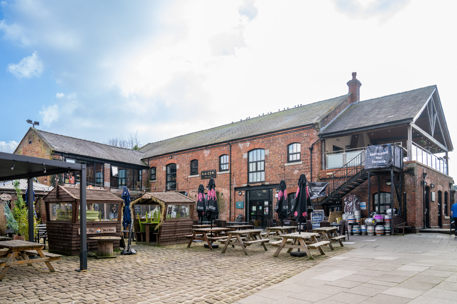 a brick building with tables and benches
