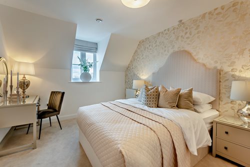 a bedroom with a bed and desk