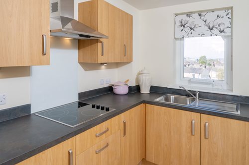 a kitchen with black counter tops