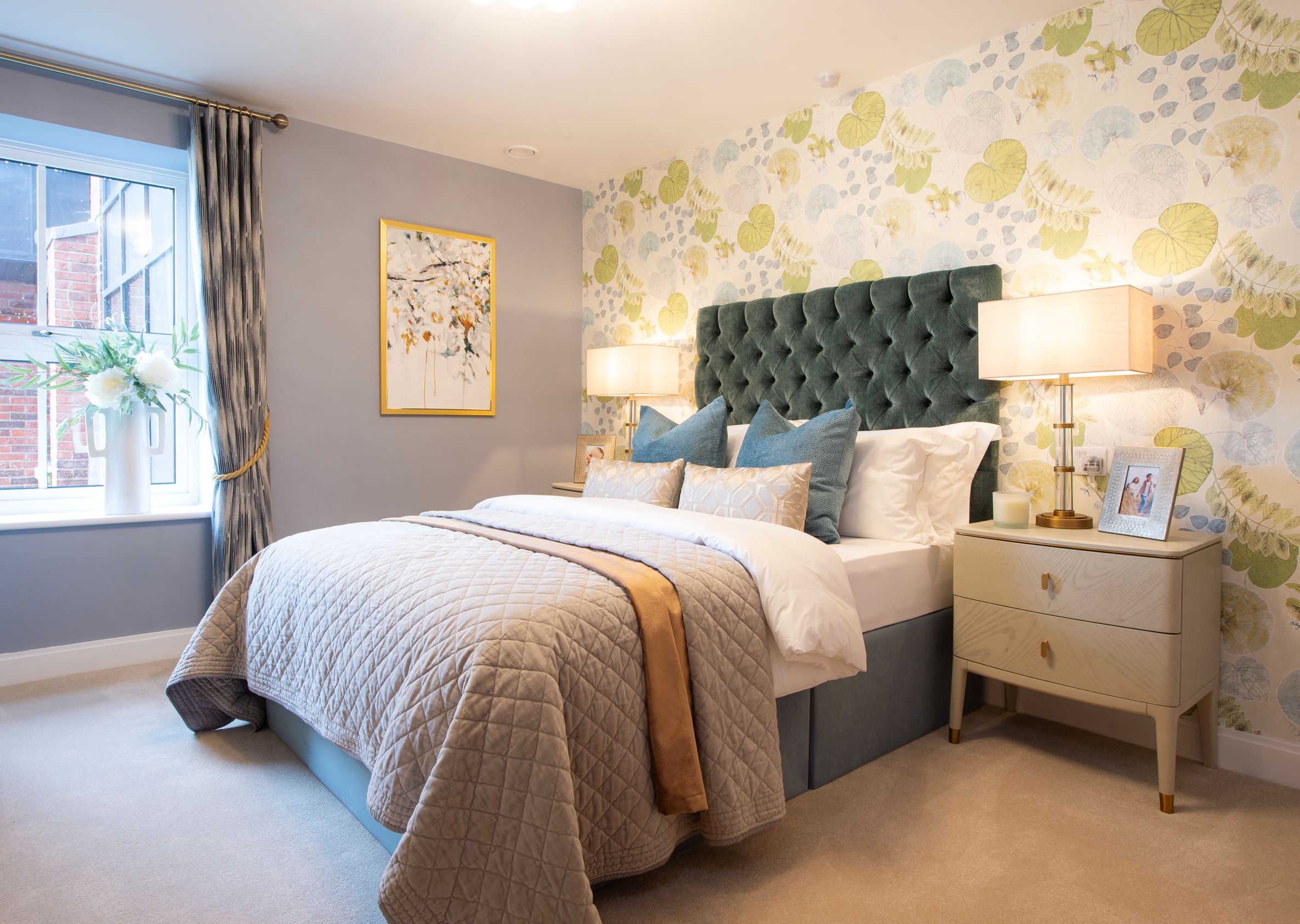 a bedroom with a bed and lamps