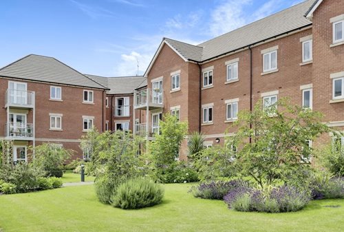 a large brick building with a garden