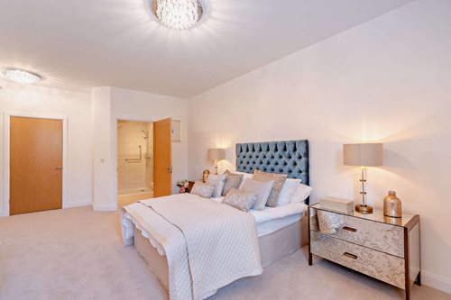 a bedroom with a bed and lamps