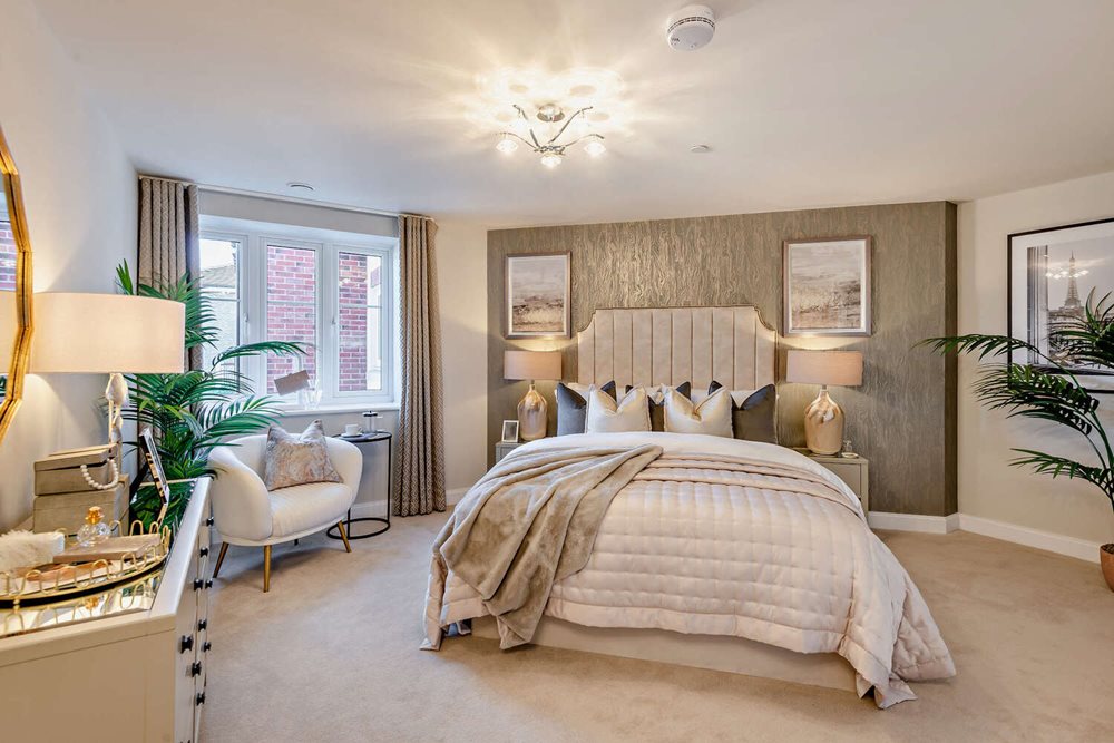 a bedroom with a bed and chairs