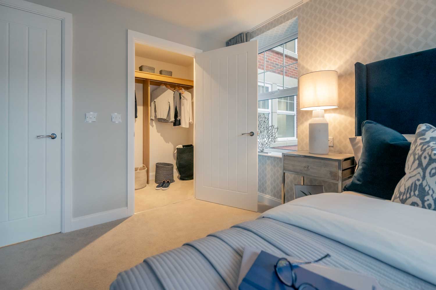 a bedroom with a bed and a lamp