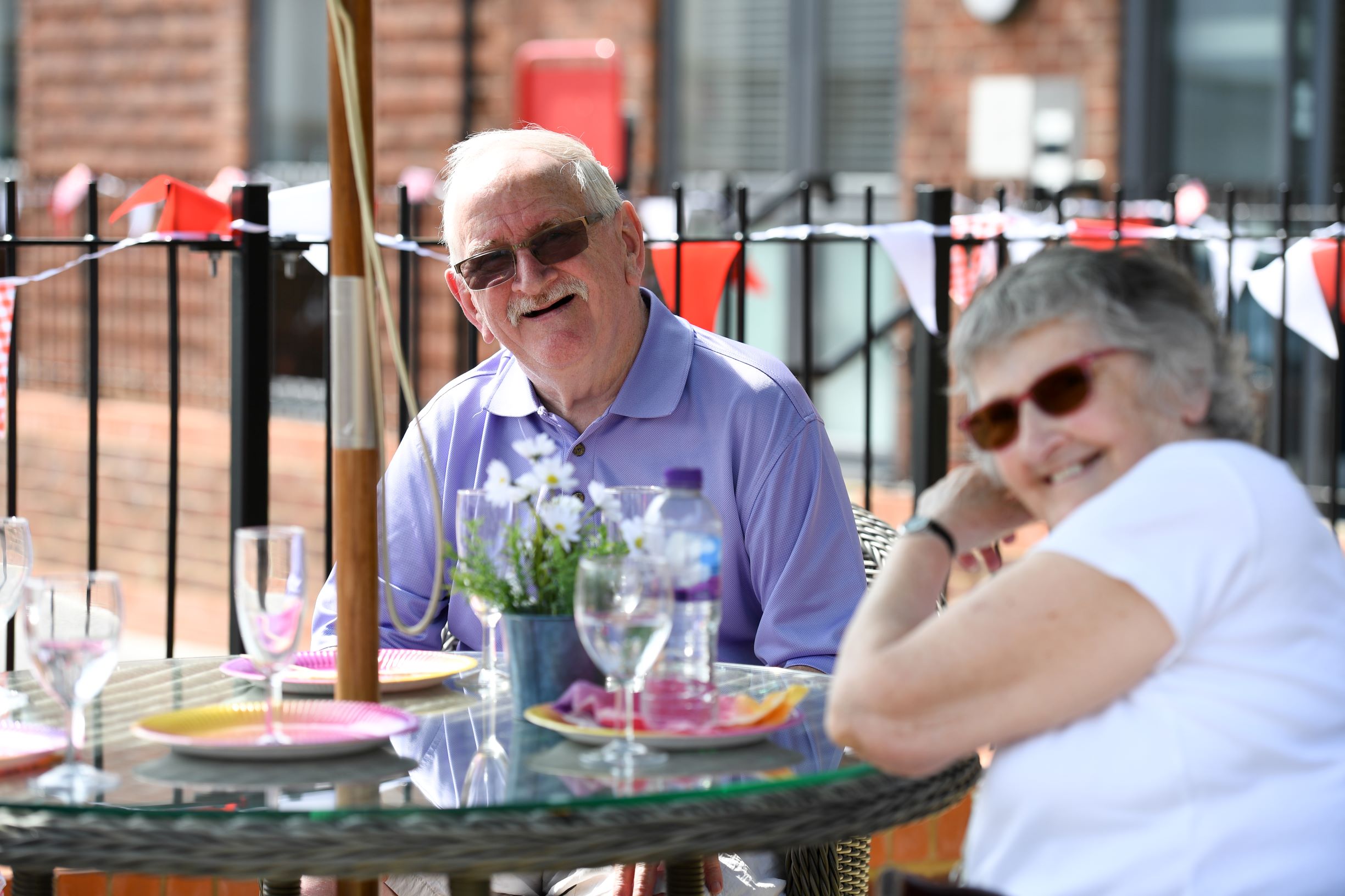 a man and woman sitting at a table with wine glasses