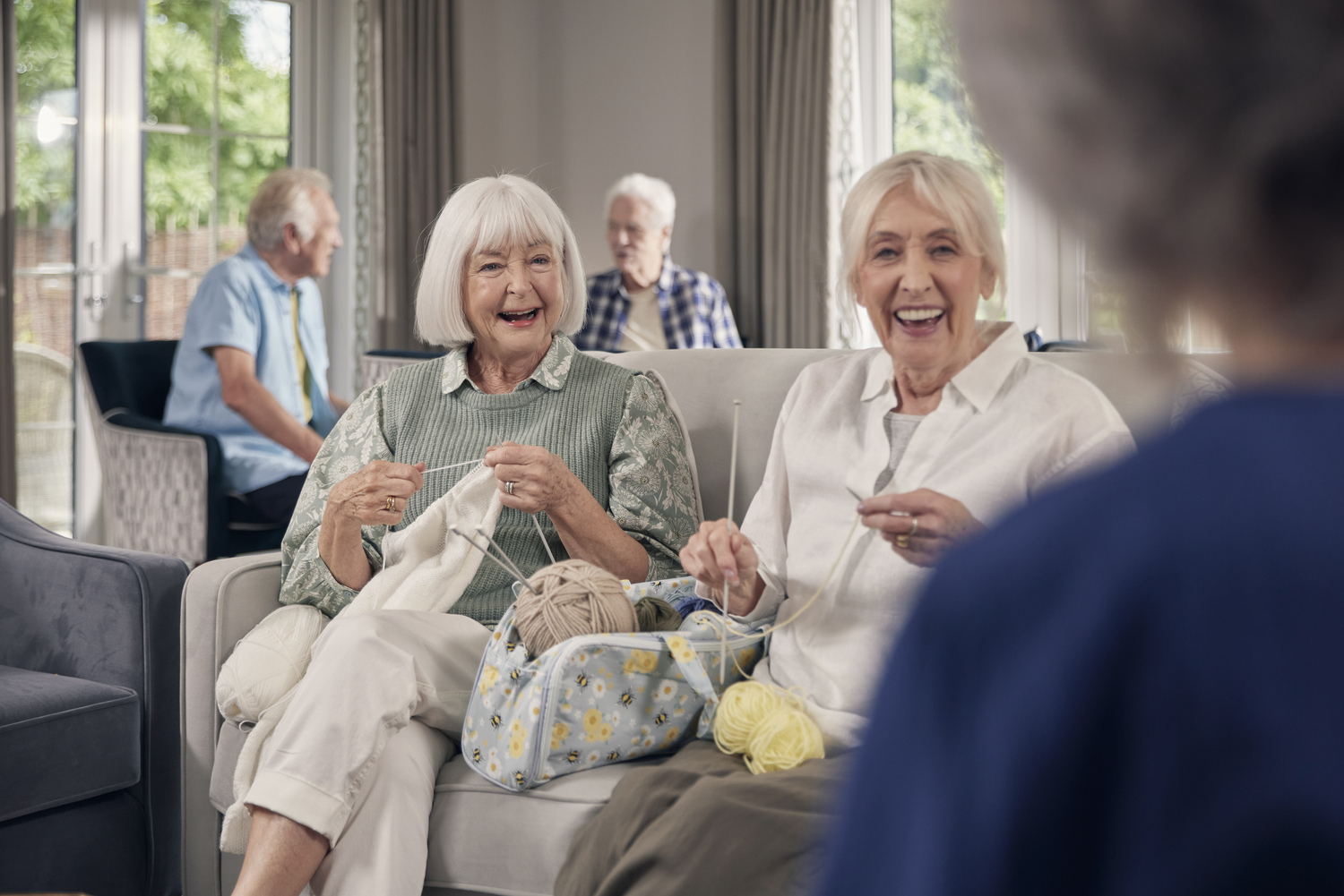 a group of elderly people sitting in chairs