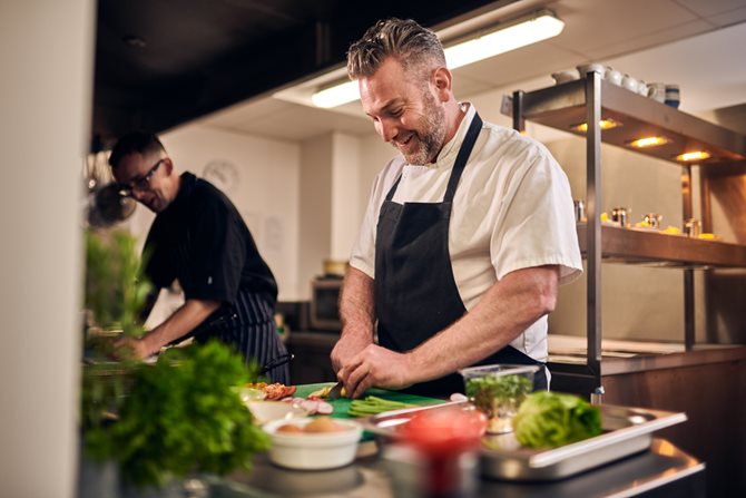 a couple of men in a kitchen