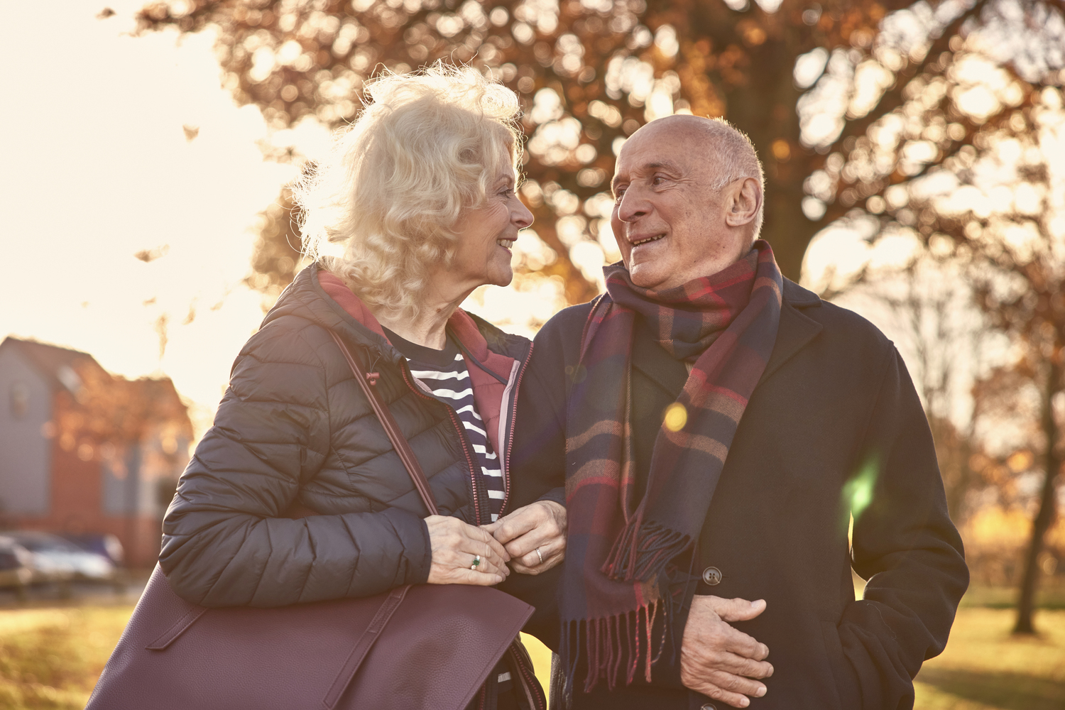a man and woman standing next to each other and looking at each other