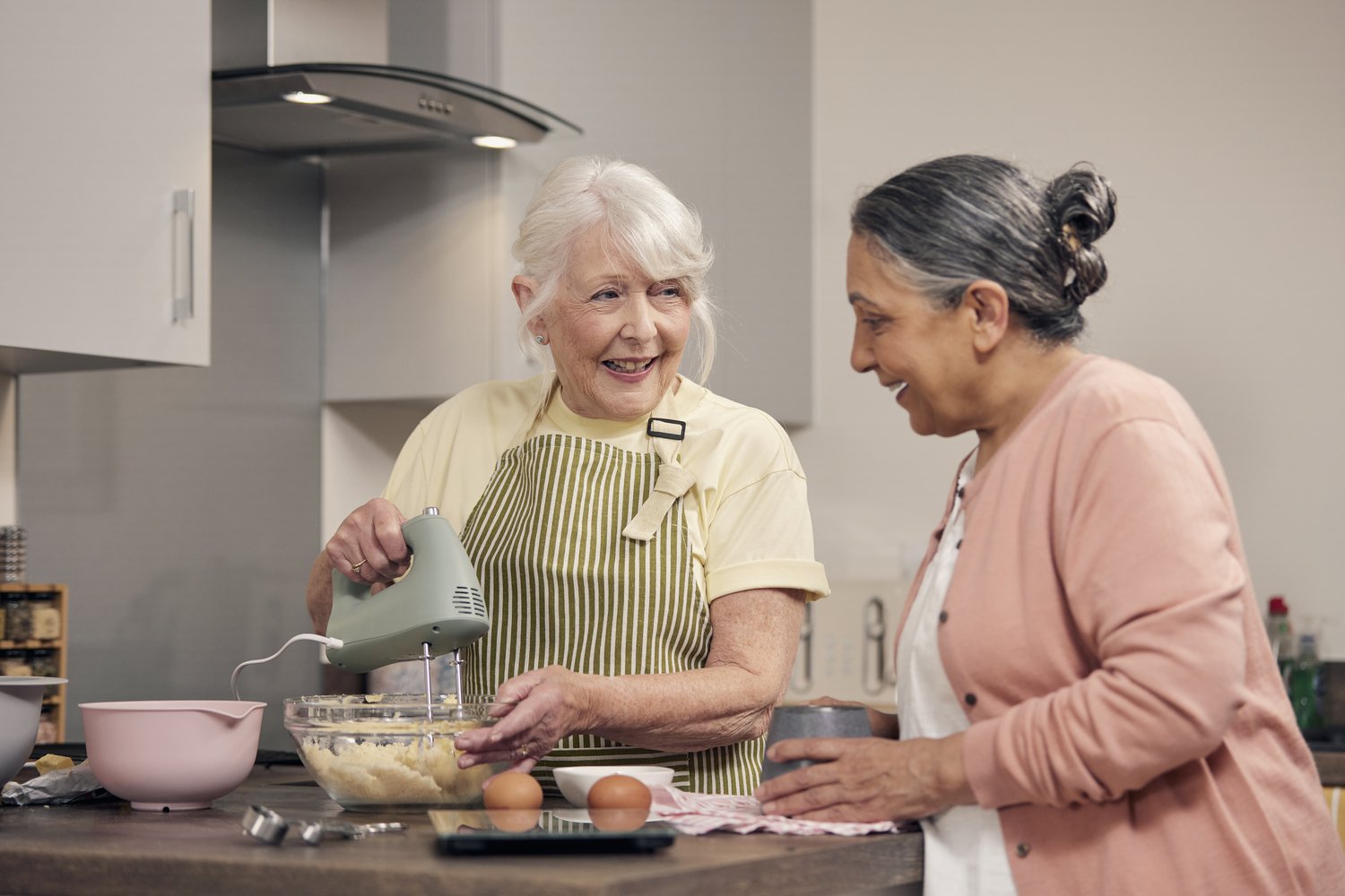 a woman and a man cooking in a kitchen